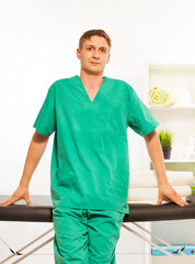 Fototapeta premium Young masseur in a uniform at the massage cabinet