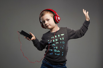 funny dancing child.little boy in headphones listening music