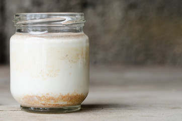Cinnamon yogurt, rustic background.