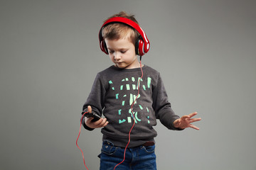 funny dancing child.little boy in headphones listening music
