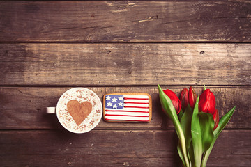 bunch of tulips, cookie and cup of coffee on the table
