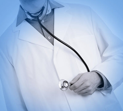 Close up of a Doctor's hand, holding a stethoscope, medical blue