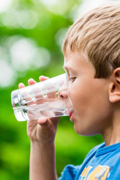 Boy drinking fresh water from glass