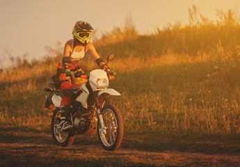 Woman biker in sunset, female motorcycle.
