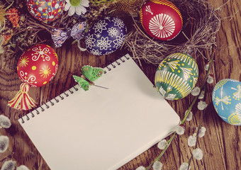 Easter greeting card colored Easter eggs over wooden background