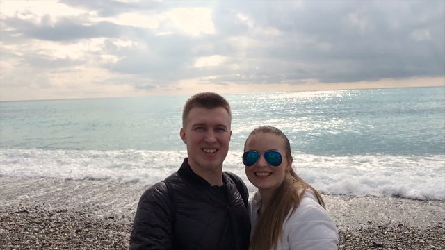Young happy couple taking selfie  on beach using smartphone mobile cell phone camera. 