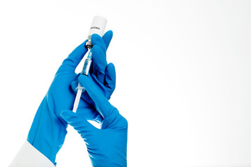 Medic holding syringe and capsule with vaccine in hand. Vaccination. Influenza