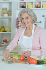 Obraz na płótnie Canvas Senior woman cooking in kitchen