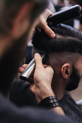 Male barber combing and shaving hair of a male client - 106431475