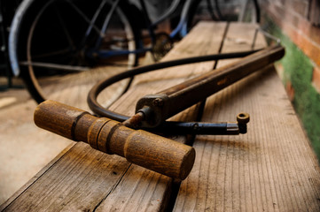 Bicycle Pump on Wood Bench with Blue Bicycle