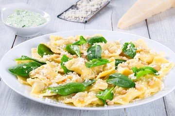 italian ravioli with creamy spinach sauce, close-up