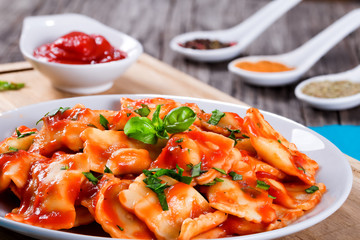  ravioli with tomato sauce and basil leaves