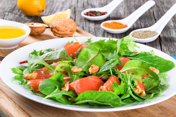 Red fish salad with mixed lettuce leaves