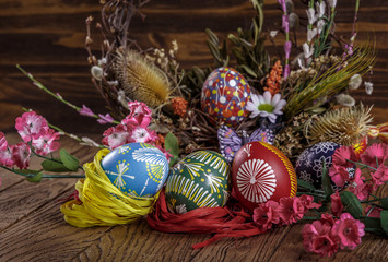 Easter background. the composition colored Easter eggs with flowers and blooming willow on the wood background