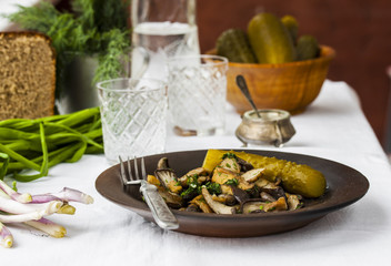 fried oyster mushrooms with garlic on a dark plate