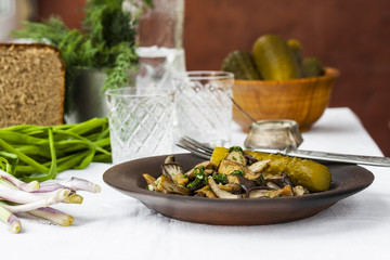 fried oyster mushrooms with garlic on a dark plate