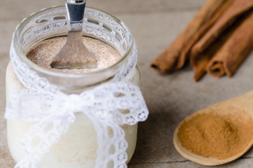 Cinnamon yogurt, rustic background.