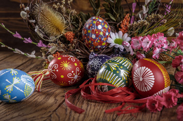 Easter background. the composition colored Easter eggs with flowers and blooming willow on the wood background