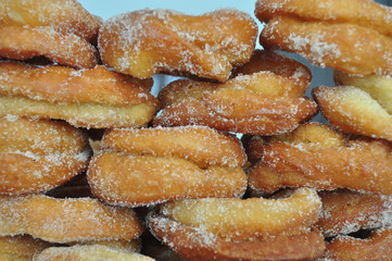wall of homemade fried donuts with sugar