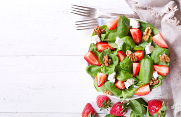 salad with strawberry, spinach leaves and feta cheese