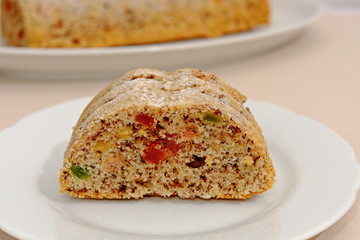 Homemade fruitcake with candied fruit on a white plate