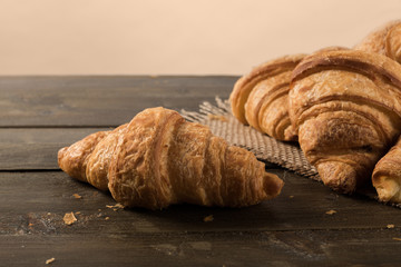 Plain croissant on rustic table