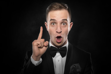 Young man shows finger up.