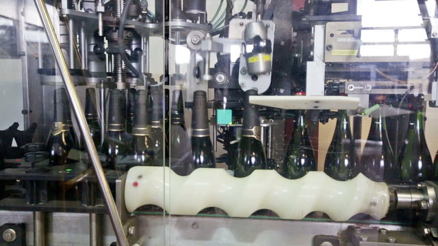 CASABLANCA, SPAIN - JANUARY 14, 2016: Sparkling wine pouring in bottles. Sumarroca - Brand cava sparkling wine produced in Catalonia
