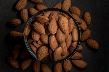 Whole Almonds Spill Over Glass Bowl