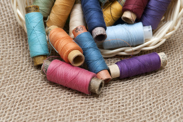 Coils with colorful threads in a wicker basket