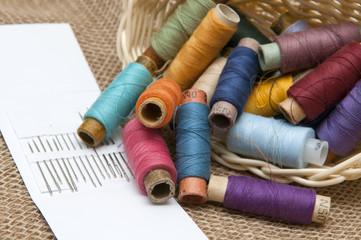Coils with colorful threads in a wicker basket