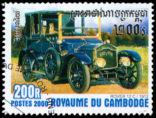 Fototapeta na wymiar Stamp printed in Kampuchea shows vintage car Rover