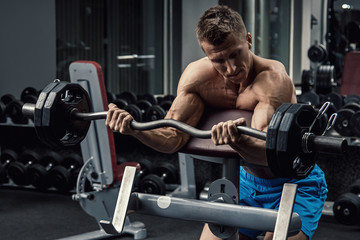 Fototapeta na wymiar Muscular man training his arms