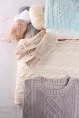 Knitted wool plaid  and clothes on light background
