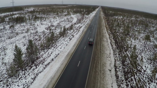 Aerial shot of the road in the countryside with car on way