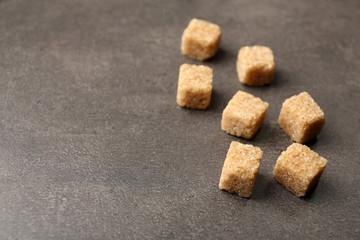 Pile of brown sugar cubes on the table