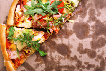 Sliced fresh pizza on cardboard background