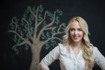 Happy blonde Business woman in front of chalk money tree drawing