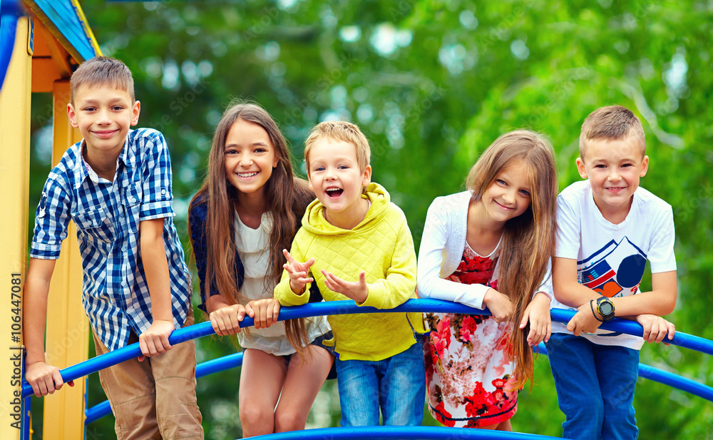 Wall mural happy excited kids having fun together on playground