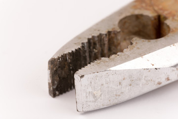 Old rusty pliers on a white background