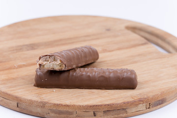 Two chocolates with a stuffing on a wooden board