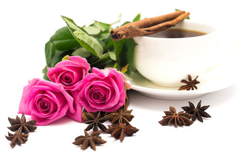 Cup of coffee with cinnamon and anise ; and bouquet of roses