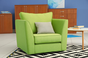 Green armchair in modern interior of living room