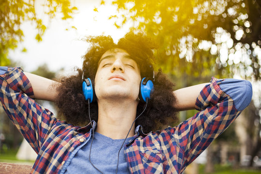 Young man listening music with earphones