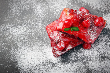 Powdered cherry strudel with mint, closeup