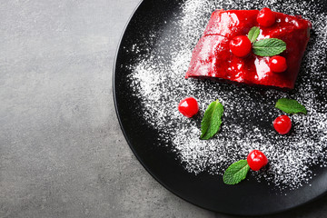 Powdered cherry strudel with mint on plate