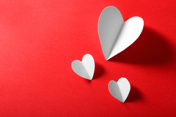 Beautiful paper hearts on dark red background