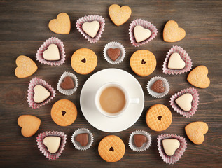 Valentine concept. Composition of cup, cookies and candies on blue background