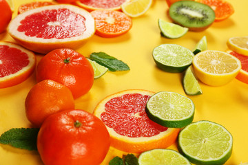Set of sliced citrus fruit on yellow background