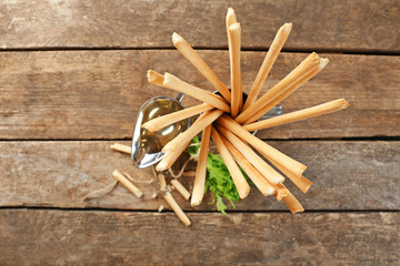 Bread sticks with arugula and oil, closeup